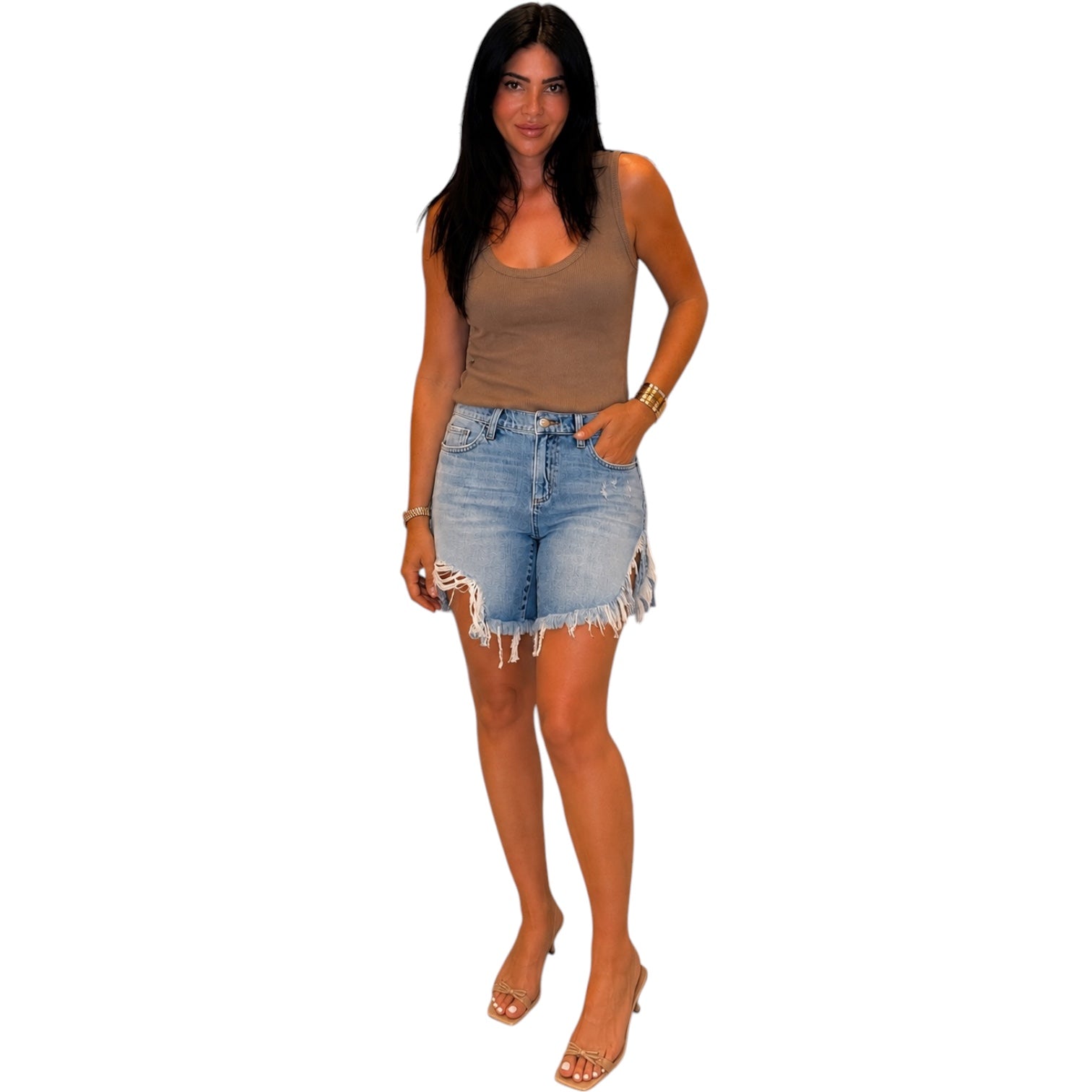 Woman wearing a brown tank top and denim shorts on a white background