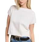 Person wearing a white t-shirt and blue jeans with a black belt on a white background