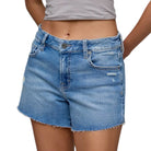 Blue denim shorts worn by a person on a white background