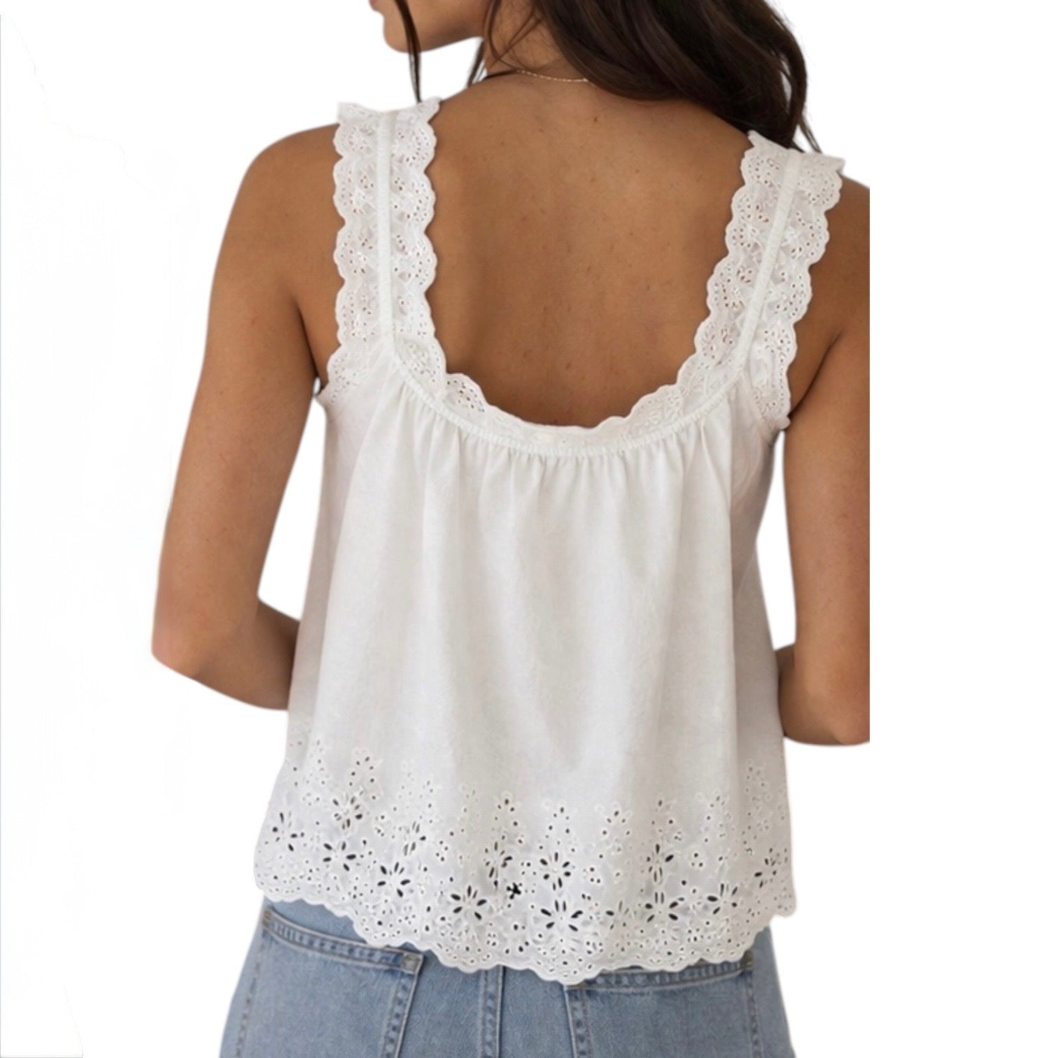 White lace-trimmed tank top worn by a person on a white background