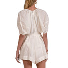 White lace romper worn by a model on a white background