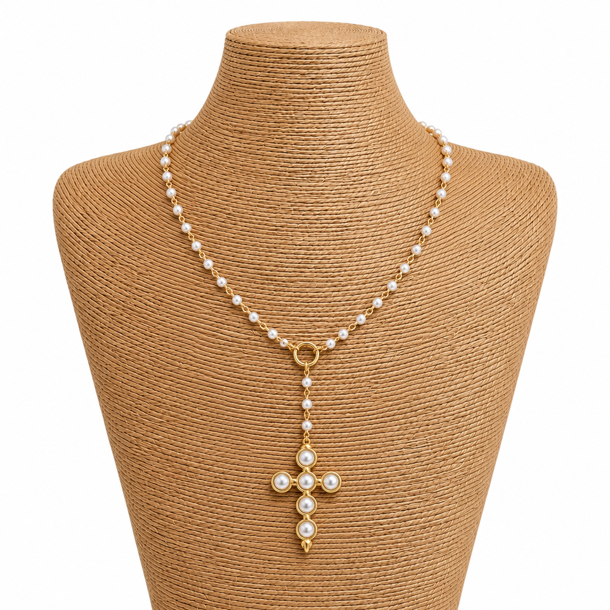 Pearl necklace with a gold cross pendant on a mannequin bust.