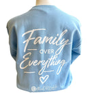 Light blue t-shirt with 'Family Over Everything' text on a mannequin against a white background