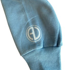Light blue sweatshirt sleeve with a logo on a white background
