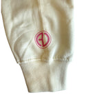 pale yellow fabric with a pink circular logo on a white background