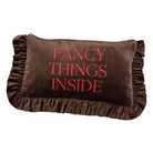 A brown velvet clutch or pouch with ruffled trim on all sides and the words 'FANCY THINGS INSIDE' embroidered in red on the front, shown against a plain white background.
