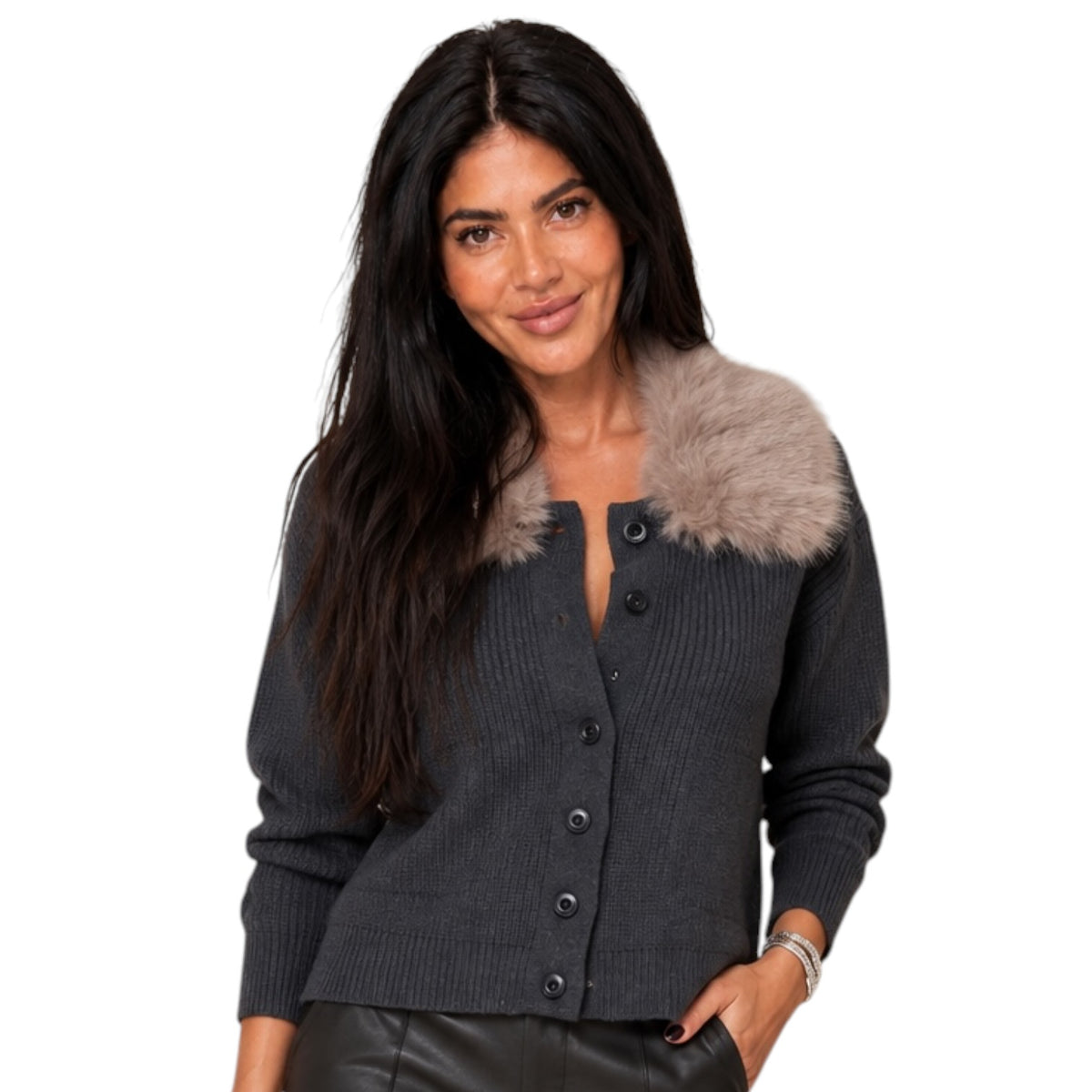 A woman wearing a dark gray ribbed knit cardigan with a light brown faux fur collar, posed against a solid white background.