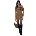 Woman wearing a brown off-shoulder dress with fur trim, black knee-high boots, and holding a matching handbag on a white background.