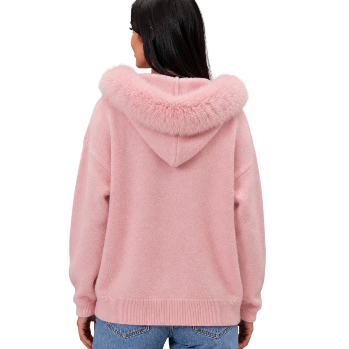 A woman viewed from the back wearing a light pink knit hoodie with a fluffy faux-fur trimmed hood, paired with blue jeans against a plain white background.