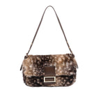 A brown faux fur shoulder bag with a spotted pattern, featuring a brown leather strap and a central brown leather flap with a gold-tone metal buckle.