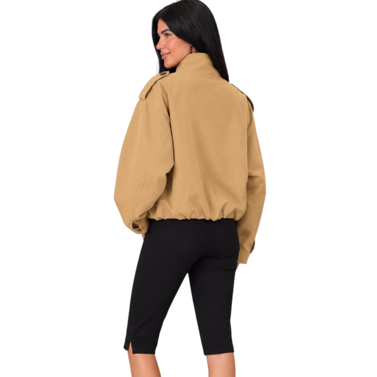 A woman shown from the back wearing a tan cropped jacket with a high collar and black capri pants, photographed against a plain white background.