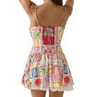 Colorful patterned dress with palm tree design on a white background
