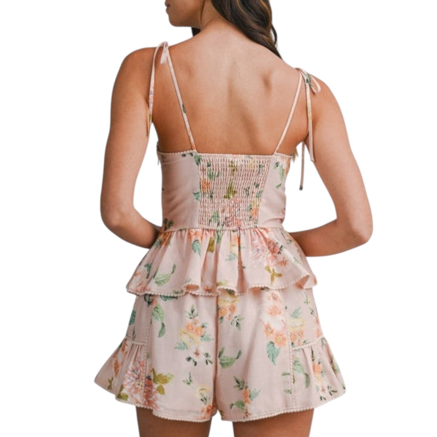 Woman wearing a floral set with thin straps on a white background