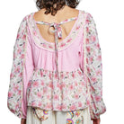 Floral blouse with a tie-back design on a white background