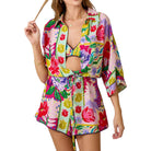 Woman wearing a colorful floral outfit on a white background