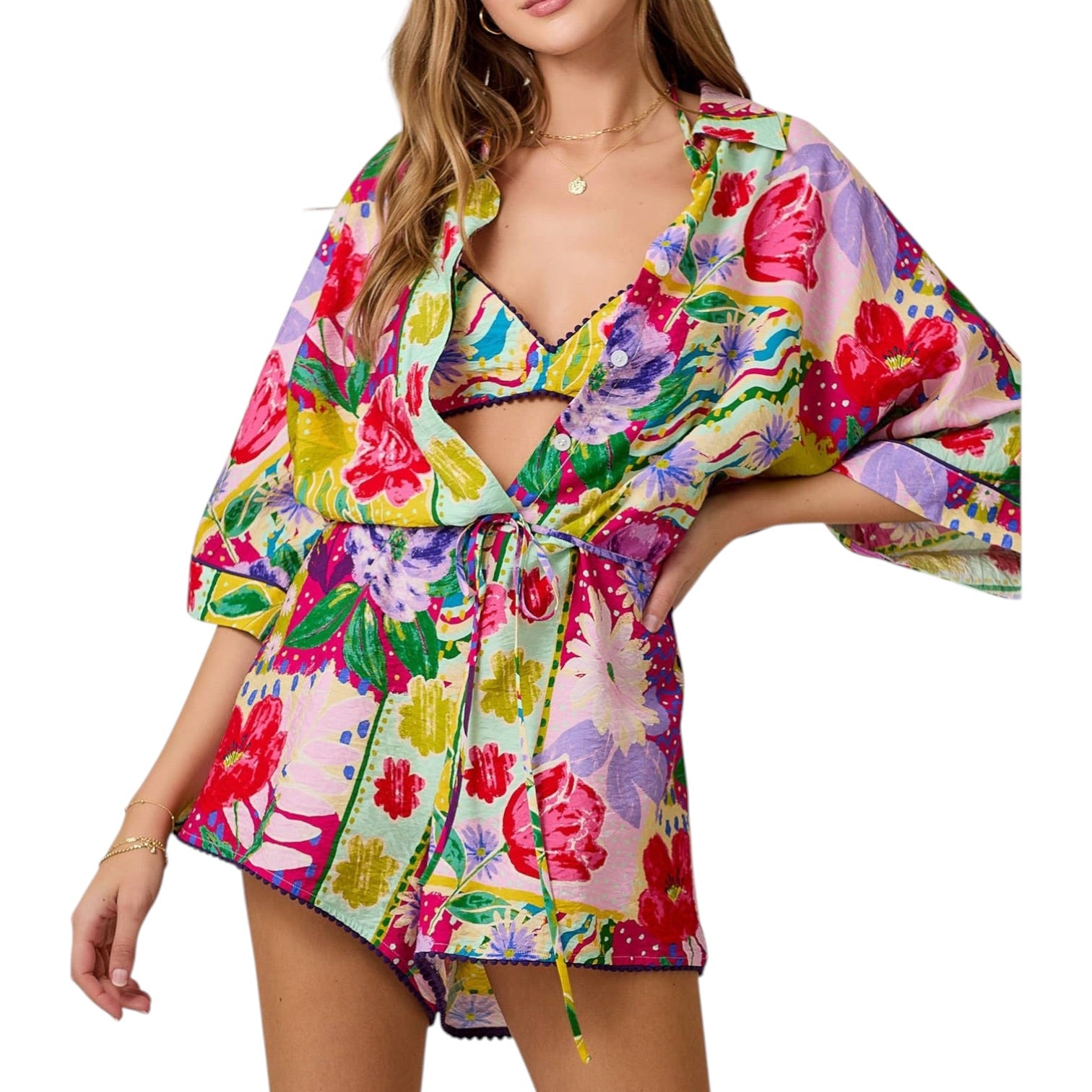 Woman wearing a colorful floral romper on a white background