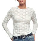 White lace long-sleeve top worn by a person on a white background