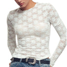 White lace long-sleeve top worn by a person on a white background