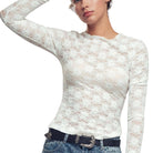 White lace long-sleeve top worn by a person on a white background