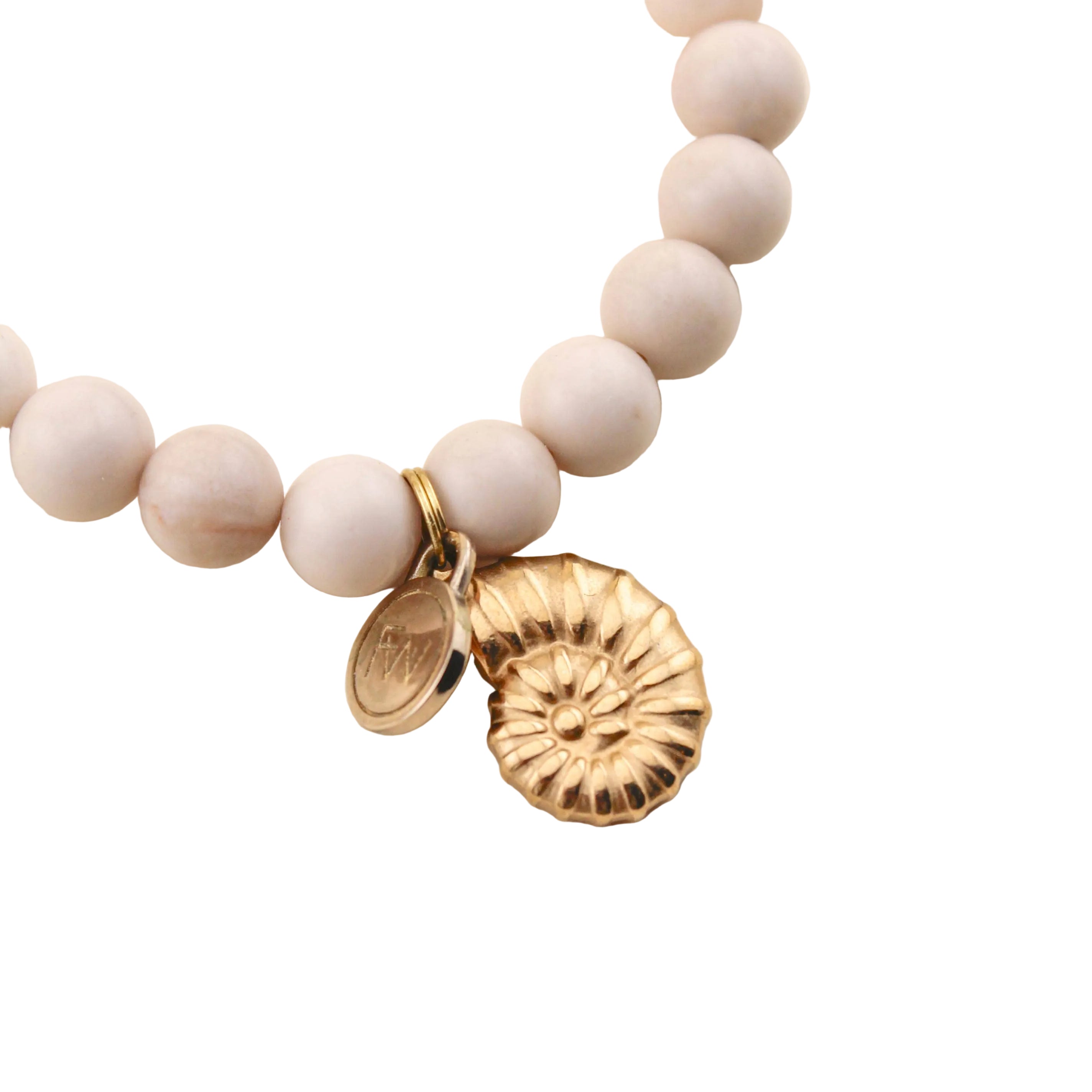Bracelet with beige beads and gold charms on a white background