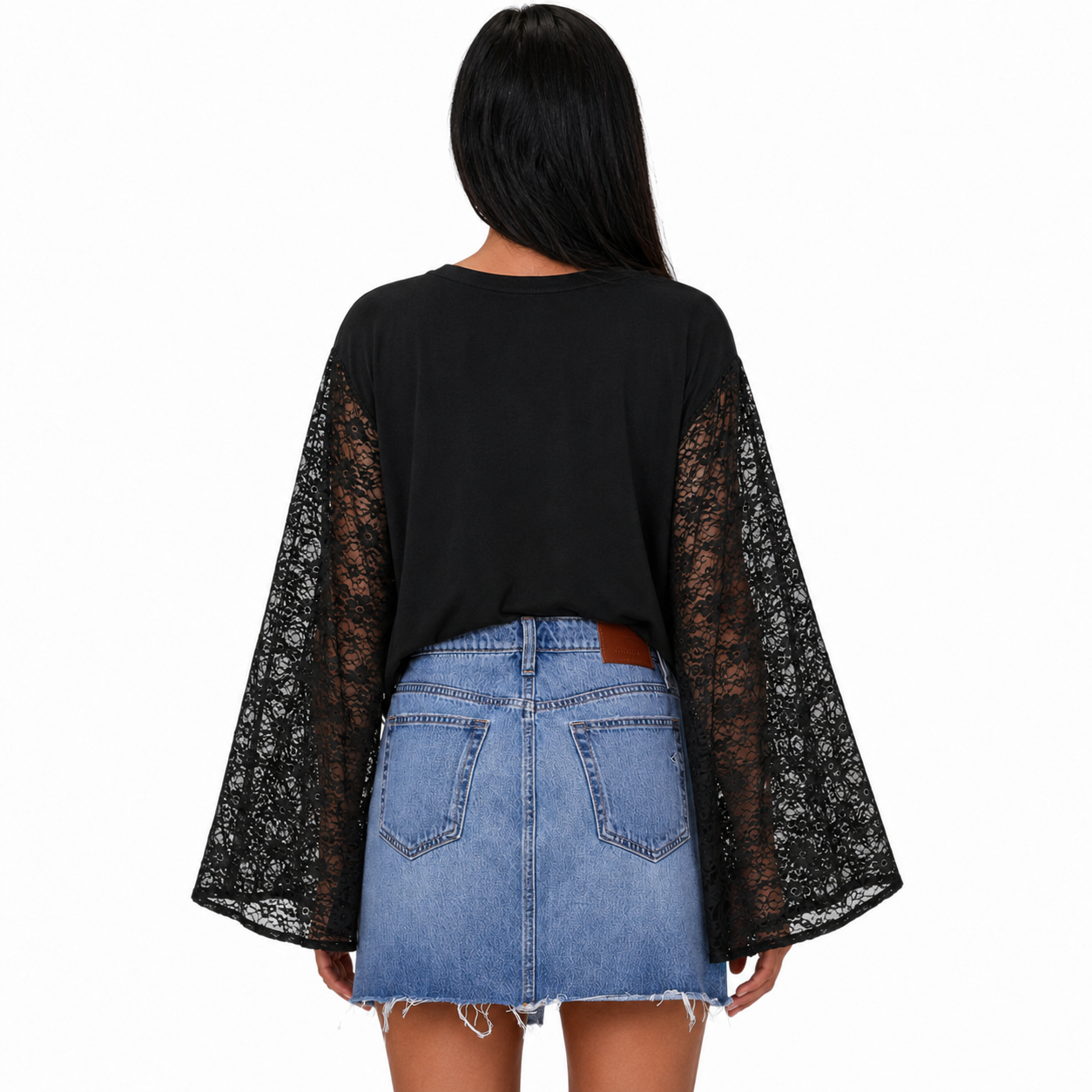 A woman shown from the back wearing a black long-sleeve top with sheer black lace bell sleeves and a light blue denim mini skirt against a plain white background.