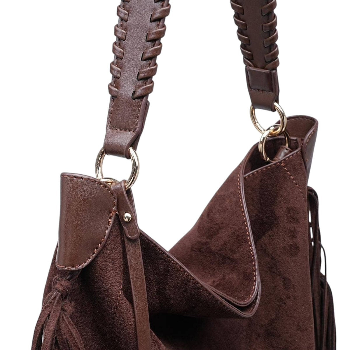 Close-up of a dark brown suede and leather shoulder bag with braided straps, gold-tone hardware, and tassel fringe, shown on a white background.