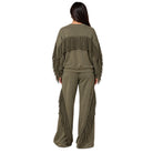 A woman viewed from the back wearing an olive green matching lounge set with fringe detailing on the sleeves and legs, set against a plain white background.