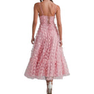 a woman wearing pink dress with butterflies on white background