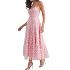 a woman wearing pink dress with butterflies on white background