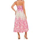 a woman wearing an ivory pink floral dress with pocket on white background.