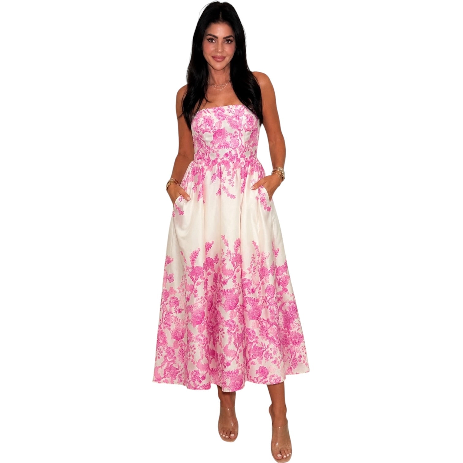 a woman wearing an ivory pink floral dress with pocket on white background.