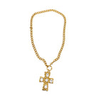 Gold chain necklace with a cross pendant on a white background