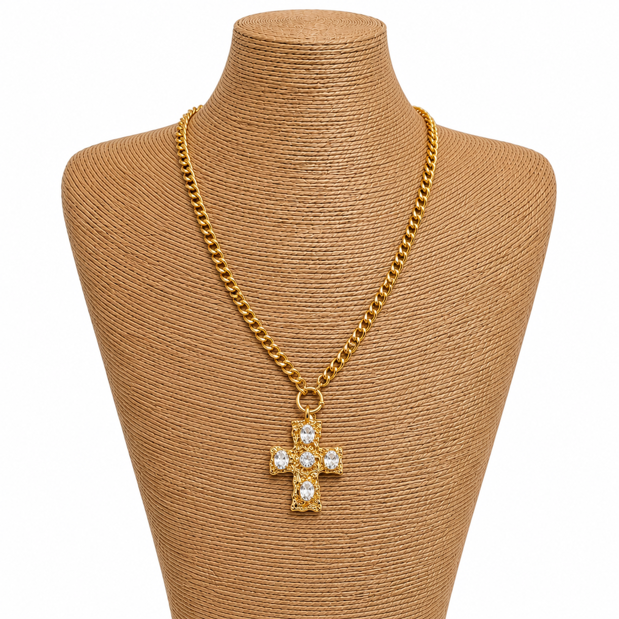 Gold chain necklace with a cross pendant on a brown mannequin bust.