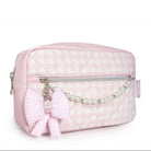 Pink quilted cosmetic bag with a bow and chain detail on a white background