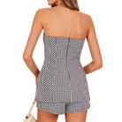 Black and white checkered strapless set worn by a model on a white background