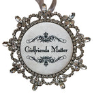 Decorative ornament with 'Girlfriends Matter' text and crystal embellishments on a white background