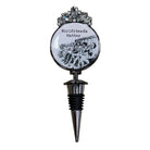 A novelty wine bottle stopper featuring a circular emblem with the text 'Girlfriends Matter' and a black-and-white photo of a group of women, topped with a silver floral crown and a metallic pointed stopper below.
