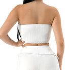 White strapless top worn by a person on a white background