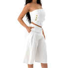 White strapless dress with cut-out design on a white background