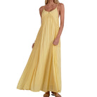 Yellow dress worn by a model on a white background