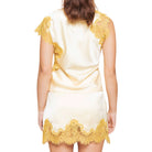 Woman wearing a yellow-colored set with yellow lace details on a white background