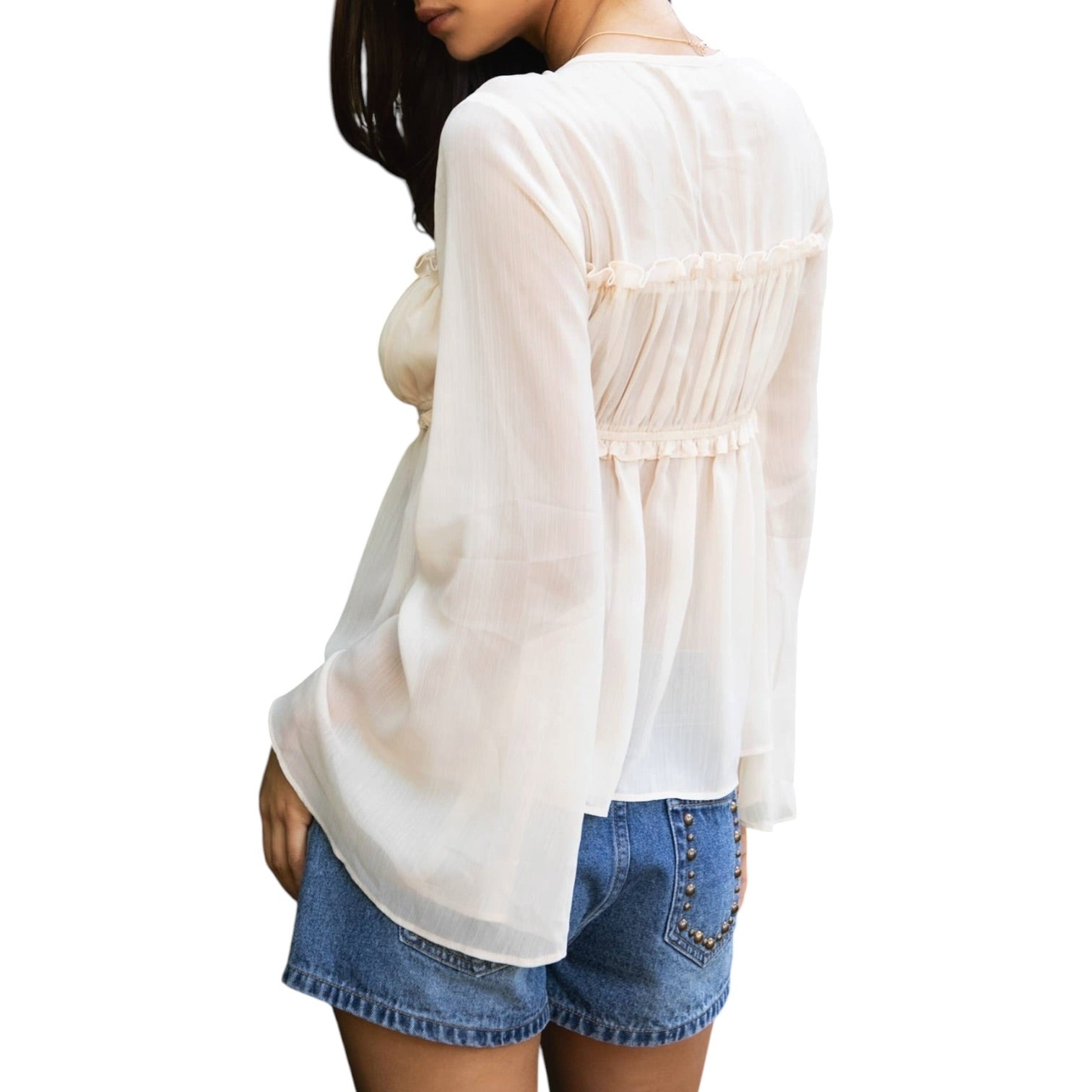 Woman wearing a white blouse and denim shorts on a white background