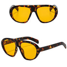 Tortoiseshell sunglasses with yellow lenses on a white background