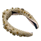 Decorative headband with embellishments on a white background