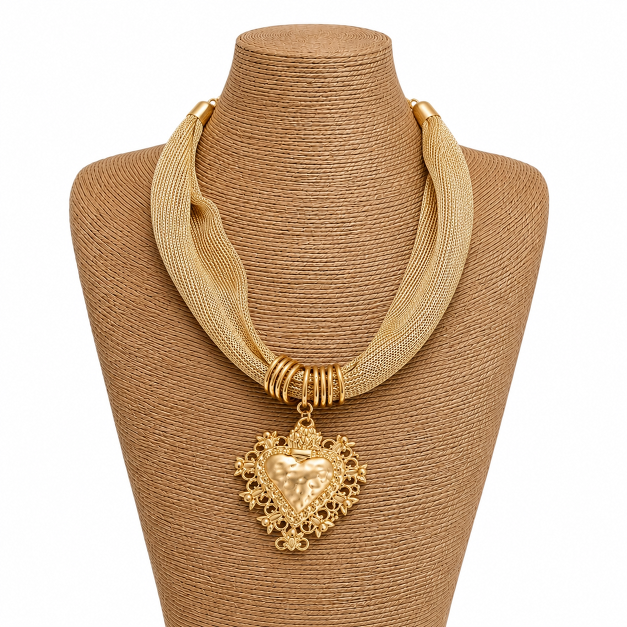 Gold necklace with a heart pendant on a brown mannequin bust.