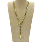 A gold-toned chunky curb chain necklace with a toggle clasp and silver-toned D-ring details, displayed on a beige fabric mannequin bust against a white background.