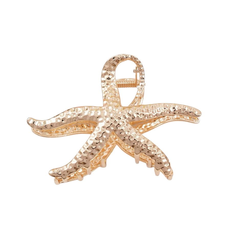 Gold starfish-shaped claw clip on a white background