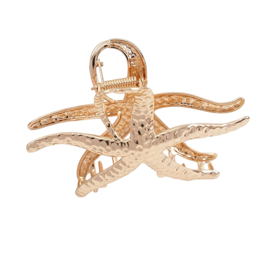 Gold starfish-shaped hair clip on a white background