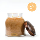 Gourmet sugar cookie-scented candle in a glass jar with a bronze lid on a white background