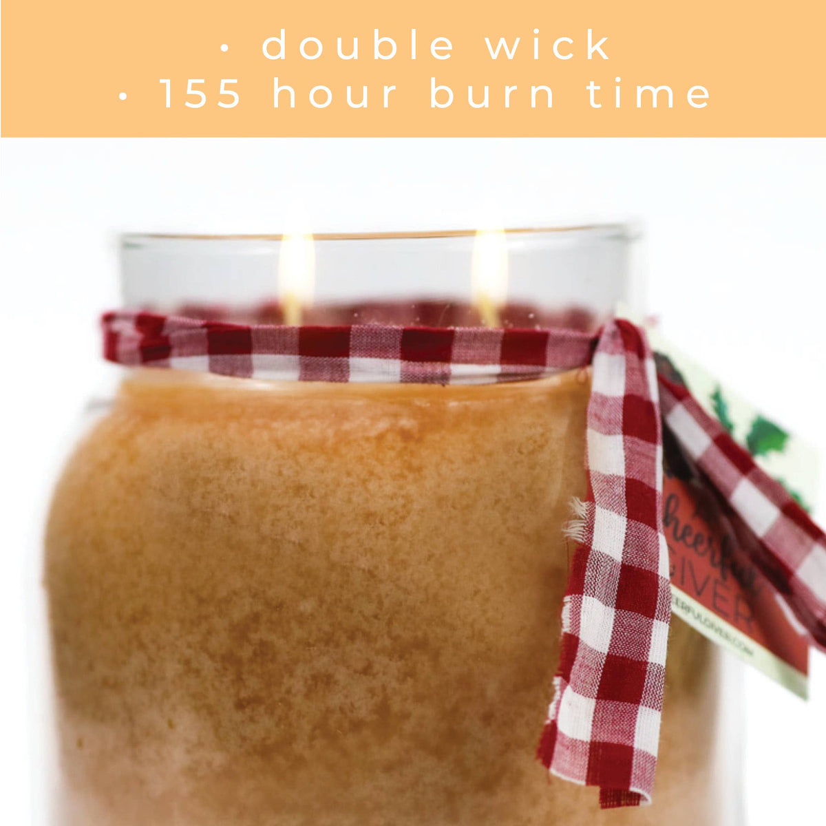 Jar with a red and white checkered ribbon, lit candles, and text about double wick and burn time.